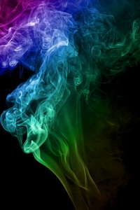 Red blue and green smoke on black photo