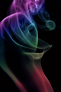 Abstract multicolored smoke on black photo