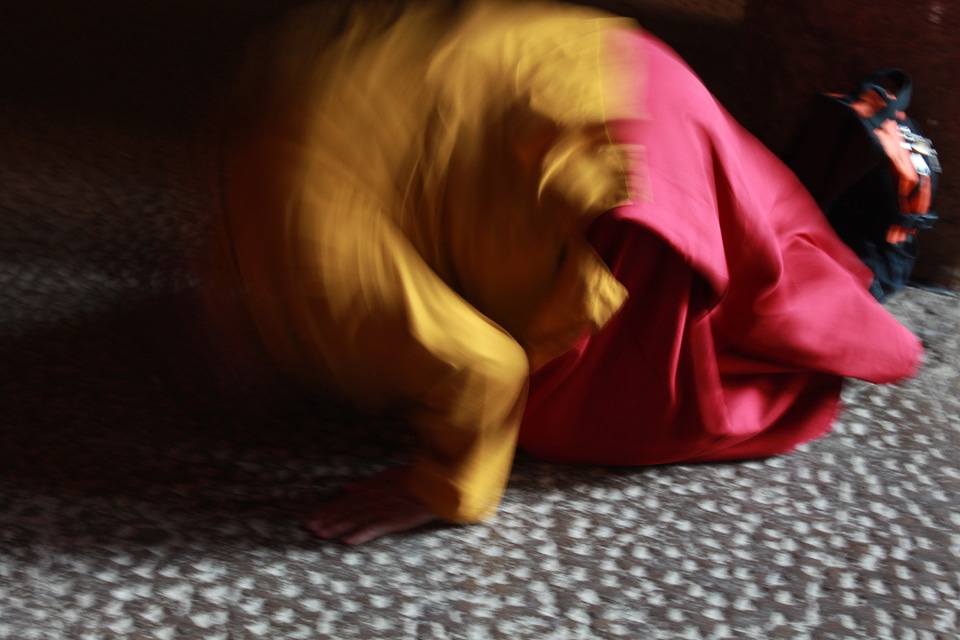 Blurry Picture Of Monk Praying