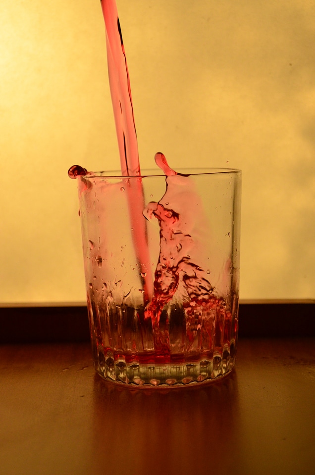 Red Liquid Falling In A Glass