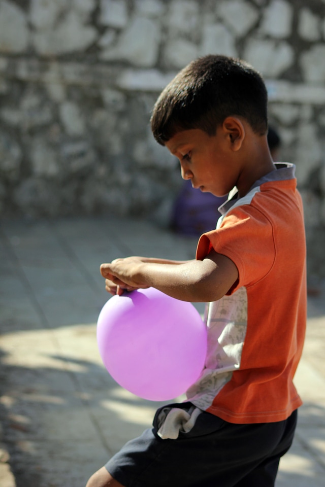 Boy Blowing Balloons