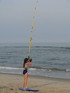 Young girl surf fishing