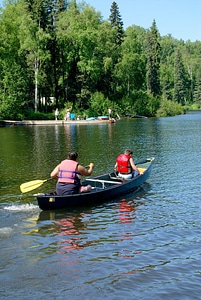 People in canoe on lake photo