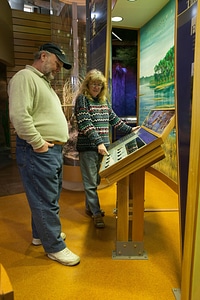 Visitors looking at an interpretative panel