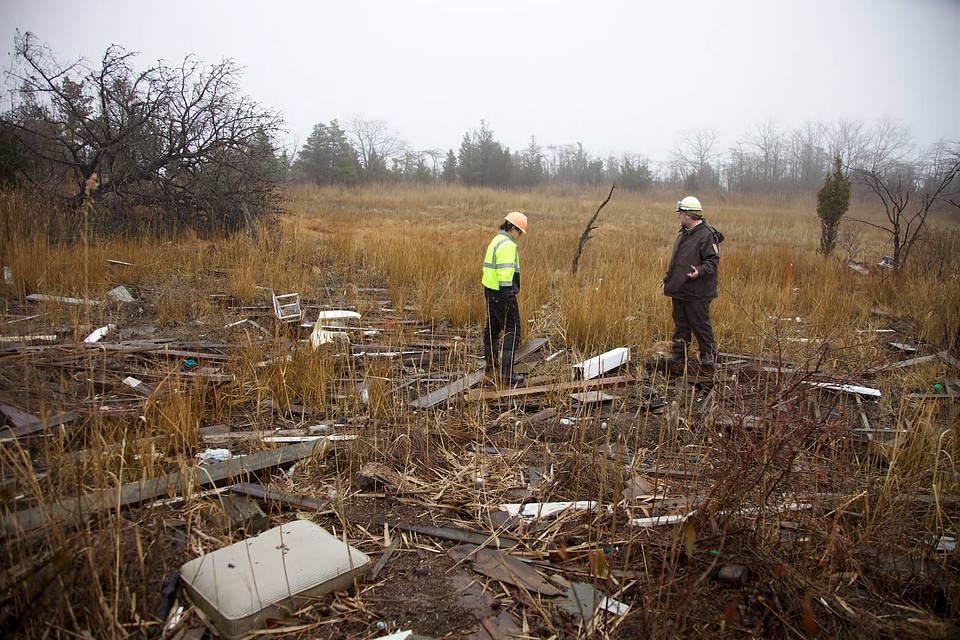 Service employees survey storm damage