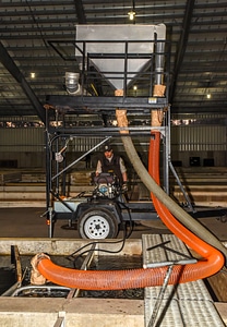 Service personnel prepare fish pump to load fish onto hatchery