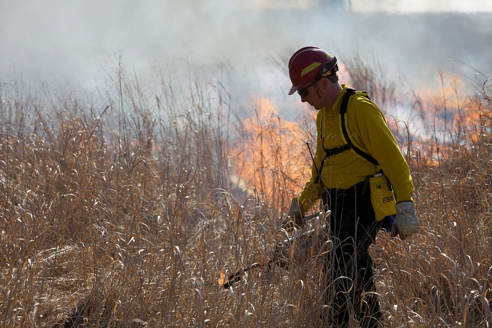 Firefighter torching field