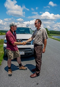 FWS staff shakes hands with young birdwatcher at truck