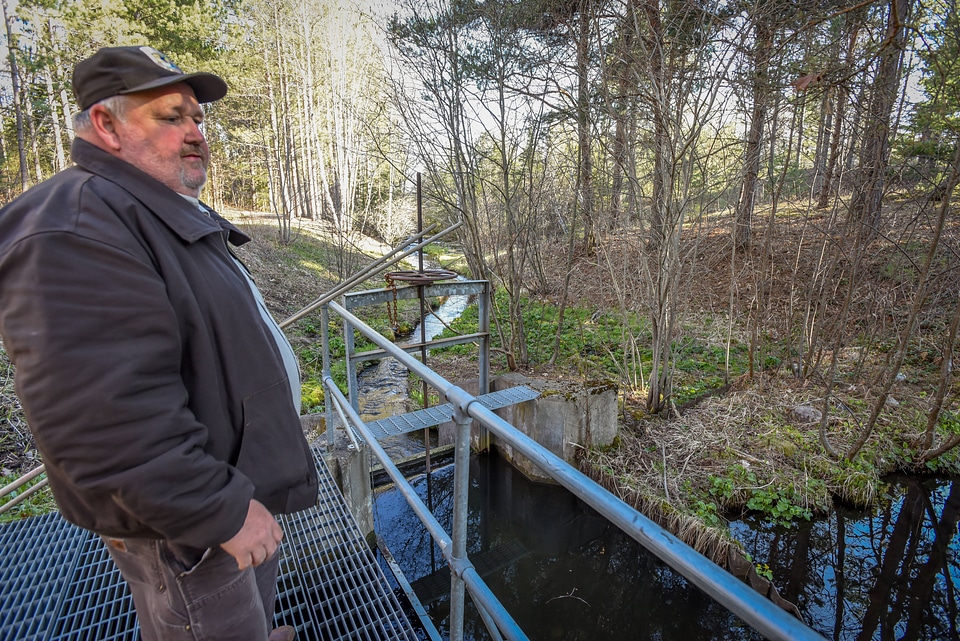 FWS employee at Pendills Creek National Fish Hatchery looking at water source