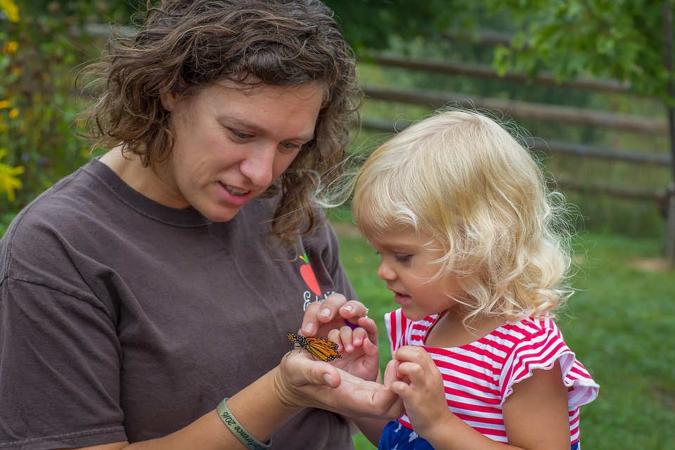 Mother and daughter with monarch butterfly
