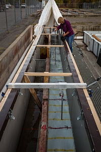 Biologist measures water velocity in a flume photo
