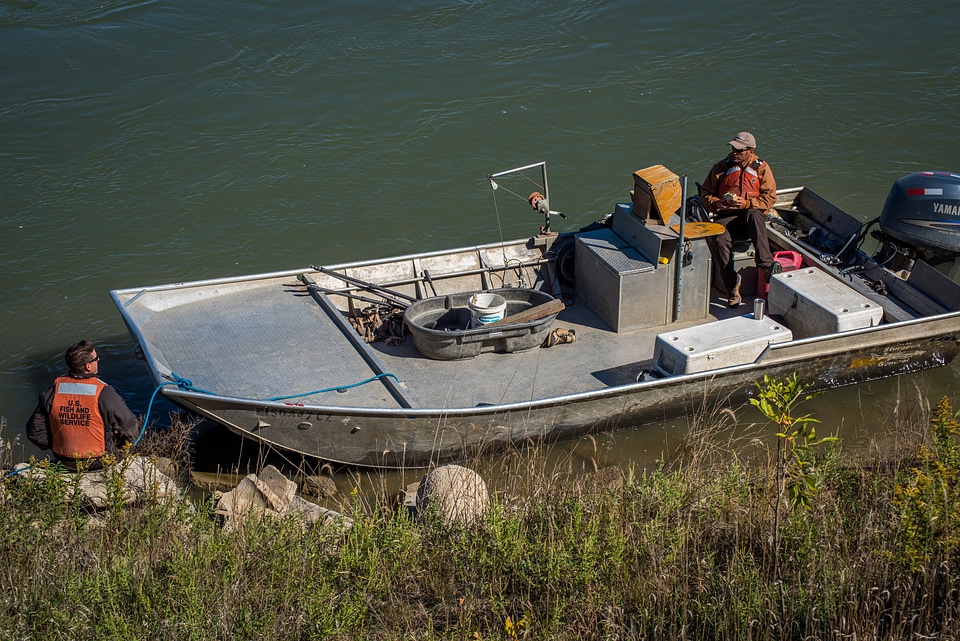 Biologists standing at boat on the Missouri River