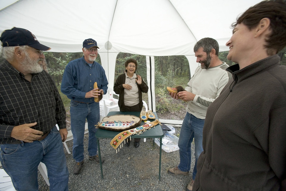 Visitors examining crafts provided by the U.S. Fish and Wildlife Service employee