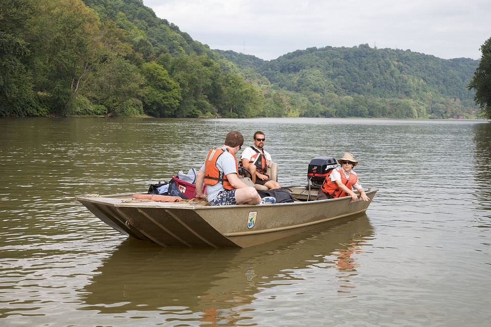 Employee in a Service boat on the Ohio River photo