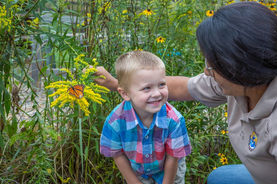 Child and FWS biologist with monarch butterfly