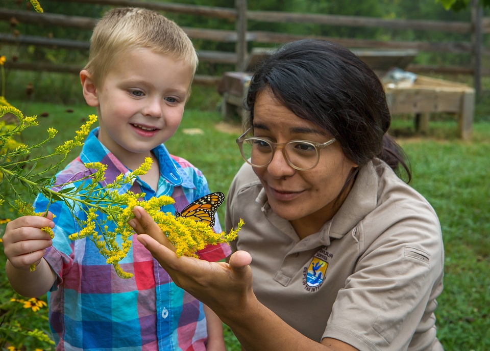 Child and FWS biologist with monarch butterfly-1