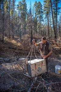 Biologist reattaches fish tank to helicopter cable