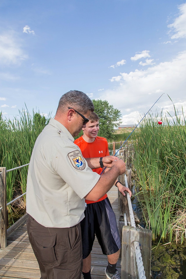 Ranger and young boy fishing