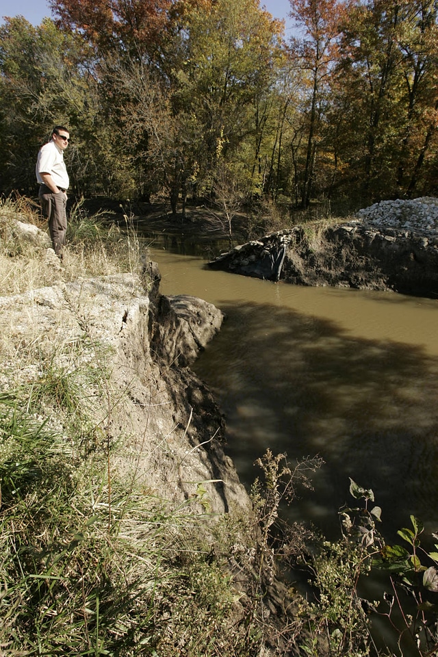 Service employee viewing flood damage