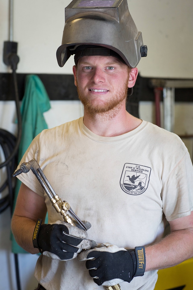 Maintenance worker with torch