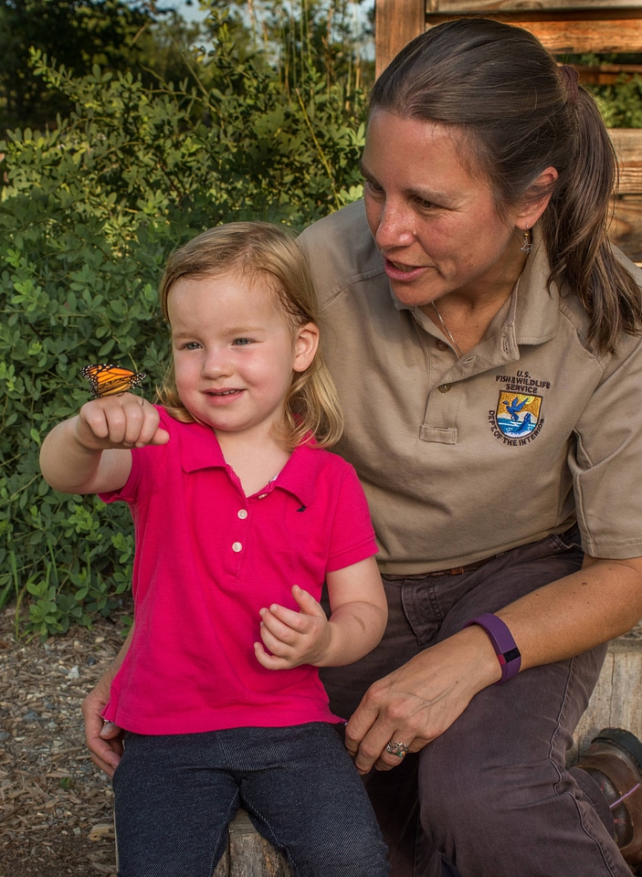 Little girl shows monarch to fws employee