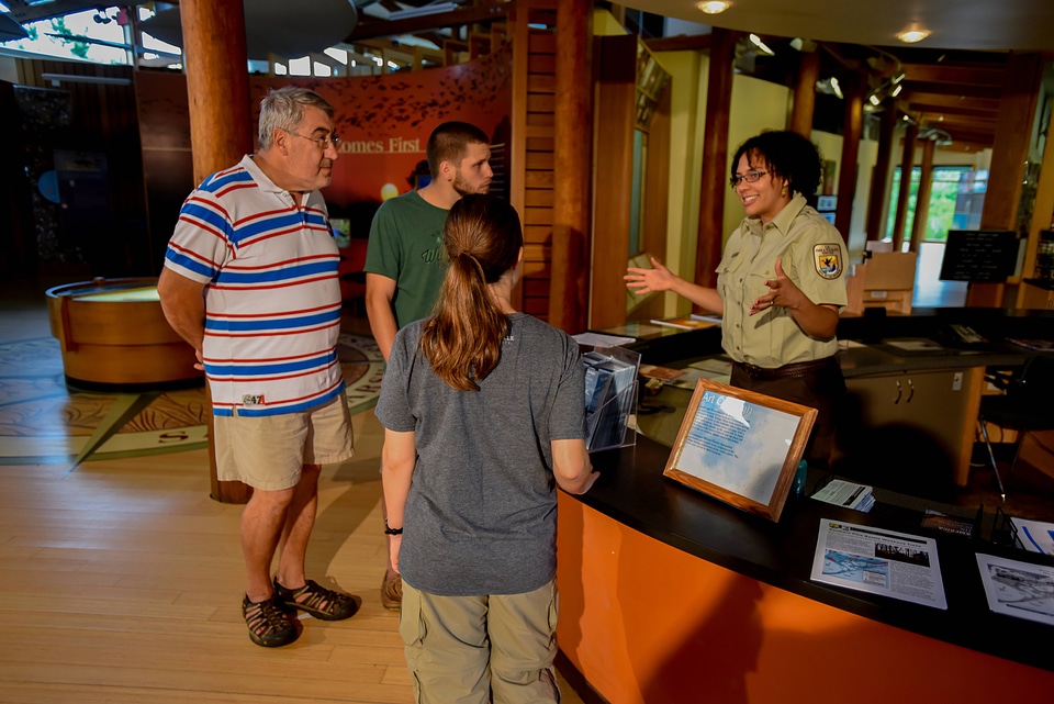 FWS Staff greets visitors at visitor center desk