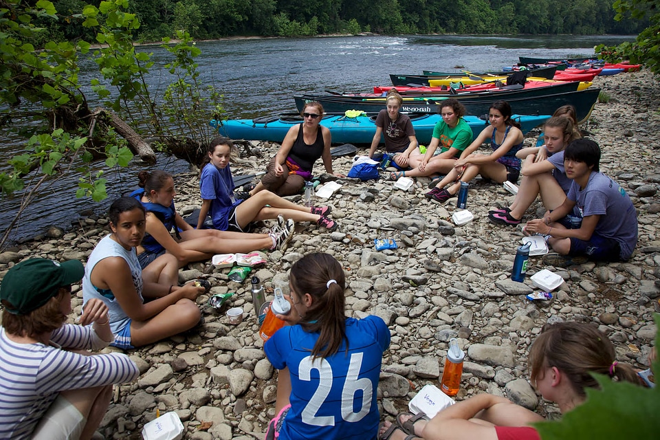 Student Climate and Conservation Congress youth relax on the shore of the Potomac River