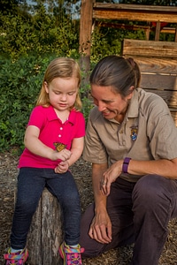 Little girl shows monarch to fws employee-1