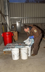 FWS employee treats water for truck livewells