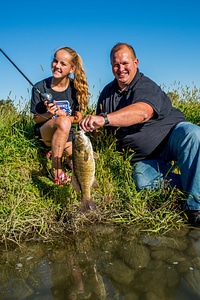 Girl with father with smallmouth bass-1