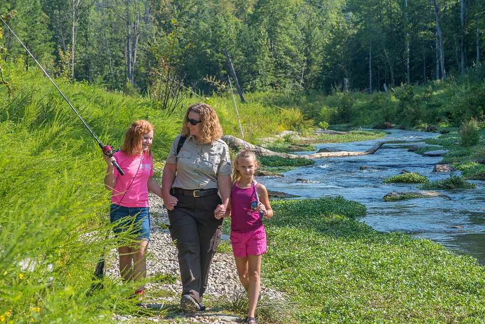Uniformed FWS employee with two girls fishing-2