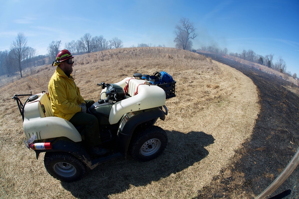 Service employee monitoring prescribed burn