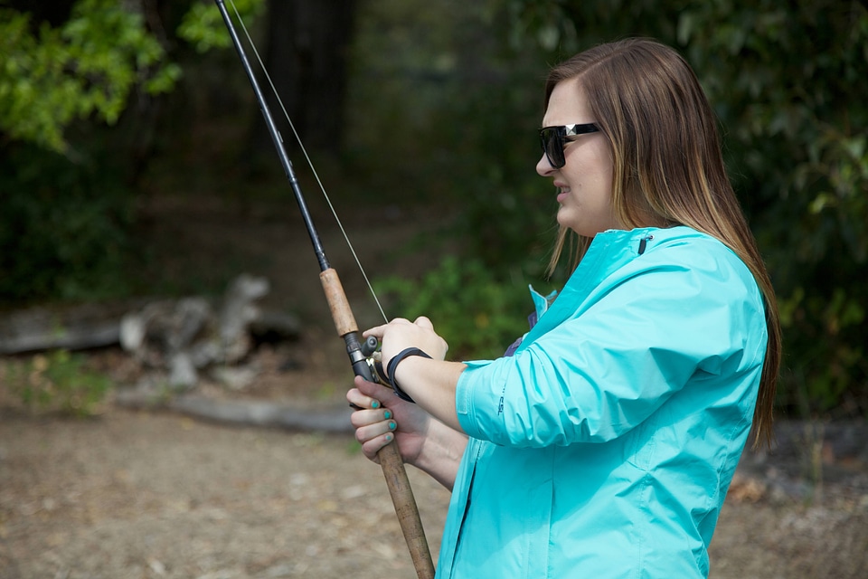 Young woman fishes for salmon