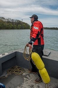 USFWS Fisheries worker thowing out buoys