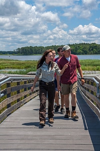 FWS staff leads group of high school students up boardwalk