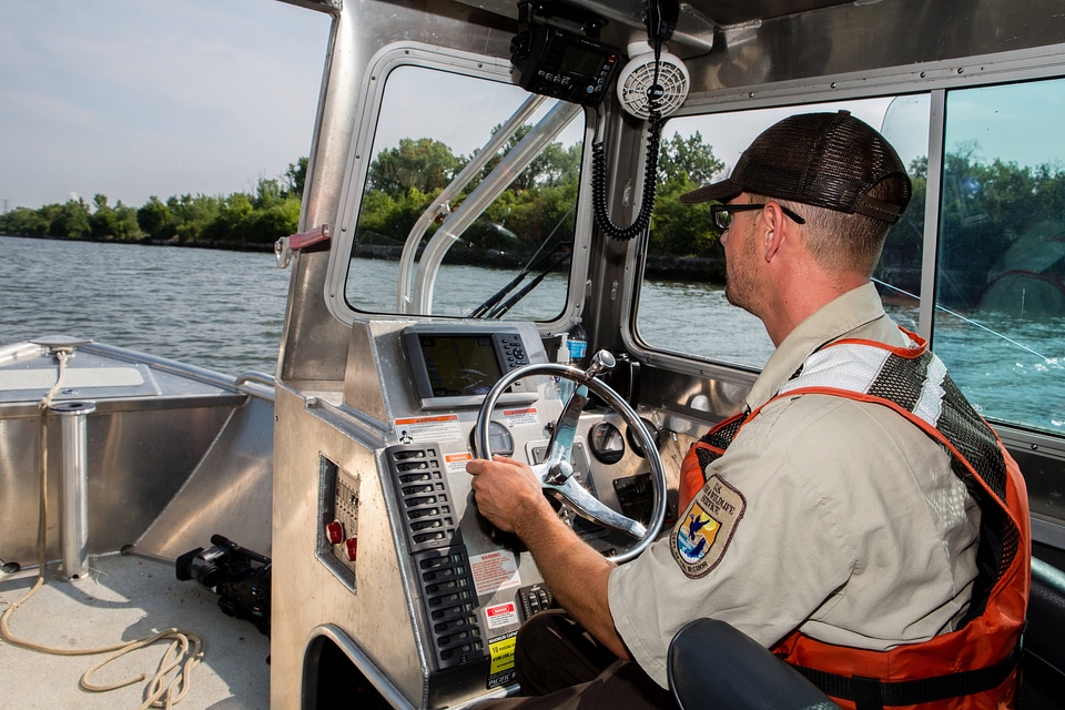Fishery biologist pilots boat while collecting data on Asian carp-2
