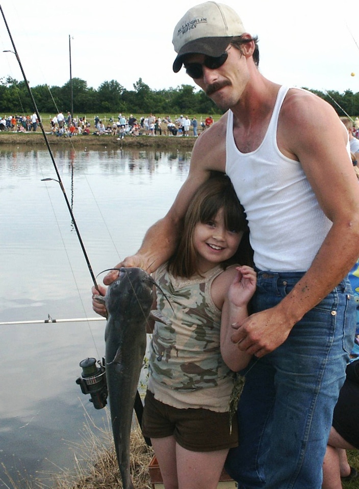 Father and daughter with catfish