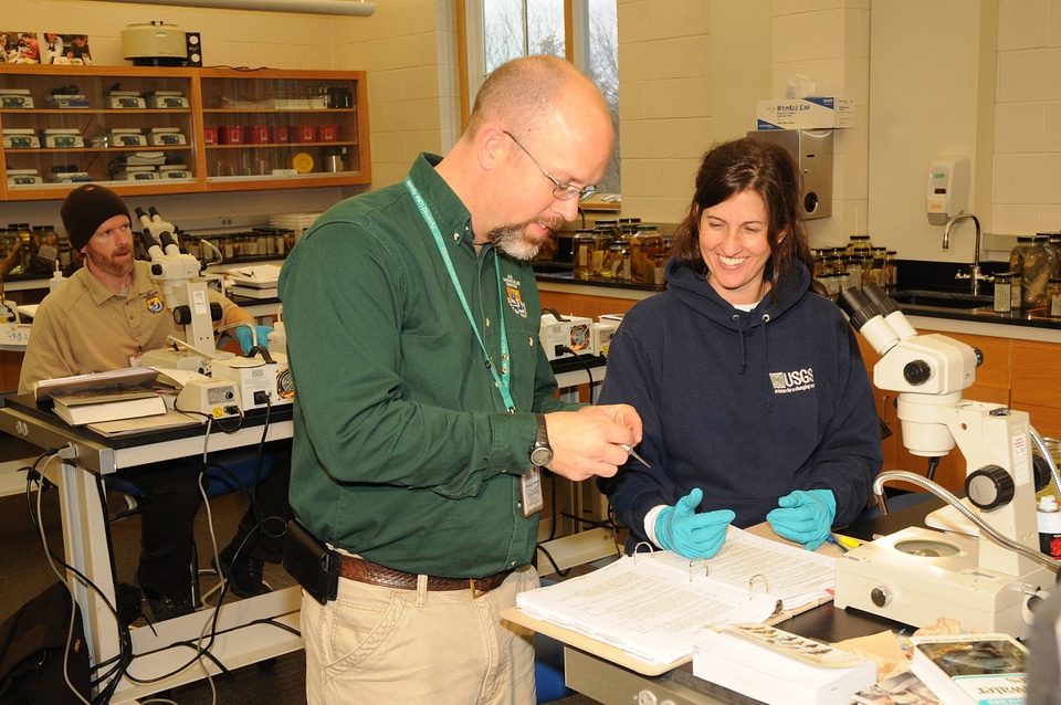 NCTC Fish ID instructor helps a student
