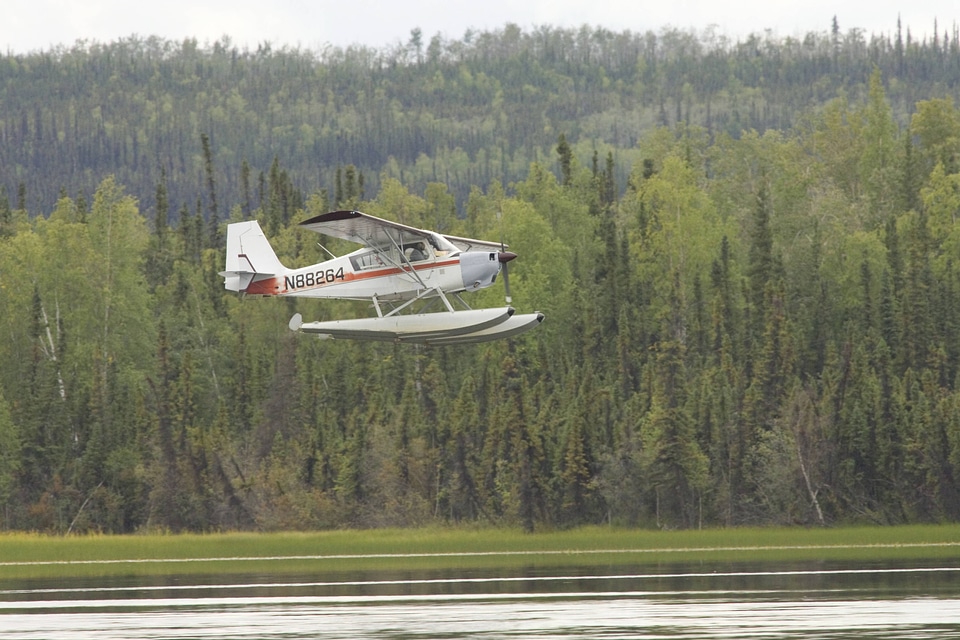 Seaplane flying over lake at Tetlin National Wildlife Refuge