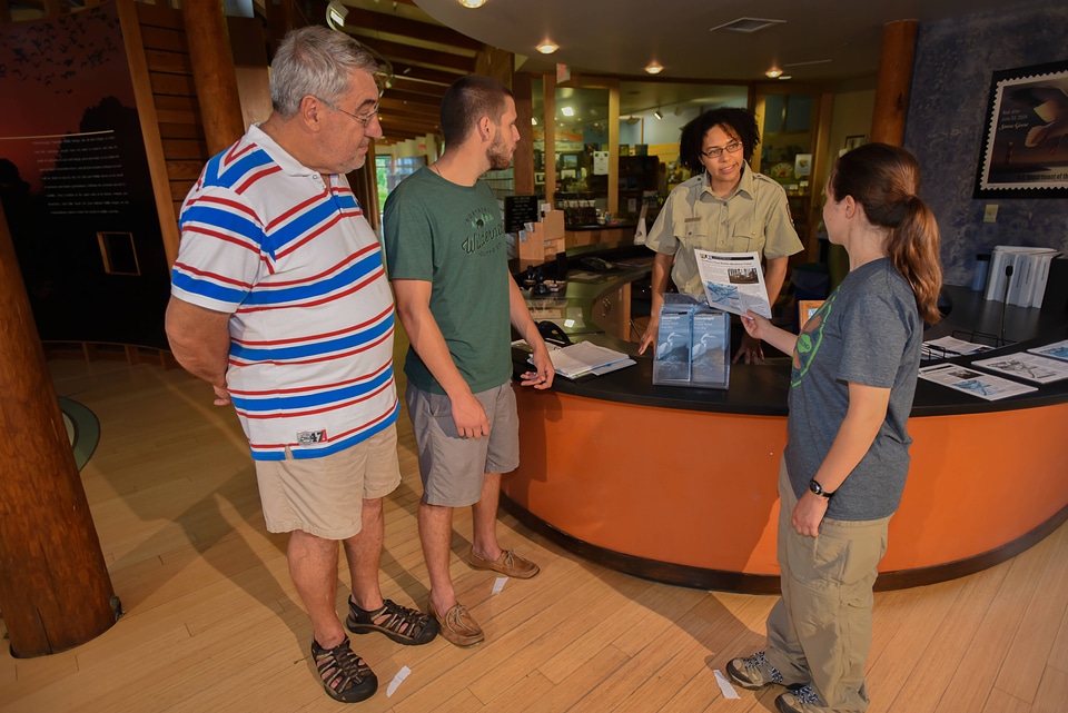 FWS Staff greets visitors at visitor center desk-1