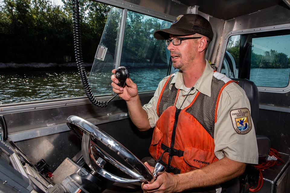 Fishery biologist pilots boat while collecting data on Asian carp-2