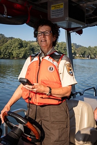 Ohio River Islands biologist, Patricia Morrison, drives a boat on the river