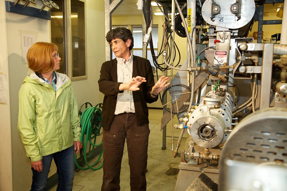 Service employee with fish nutrition research equipment