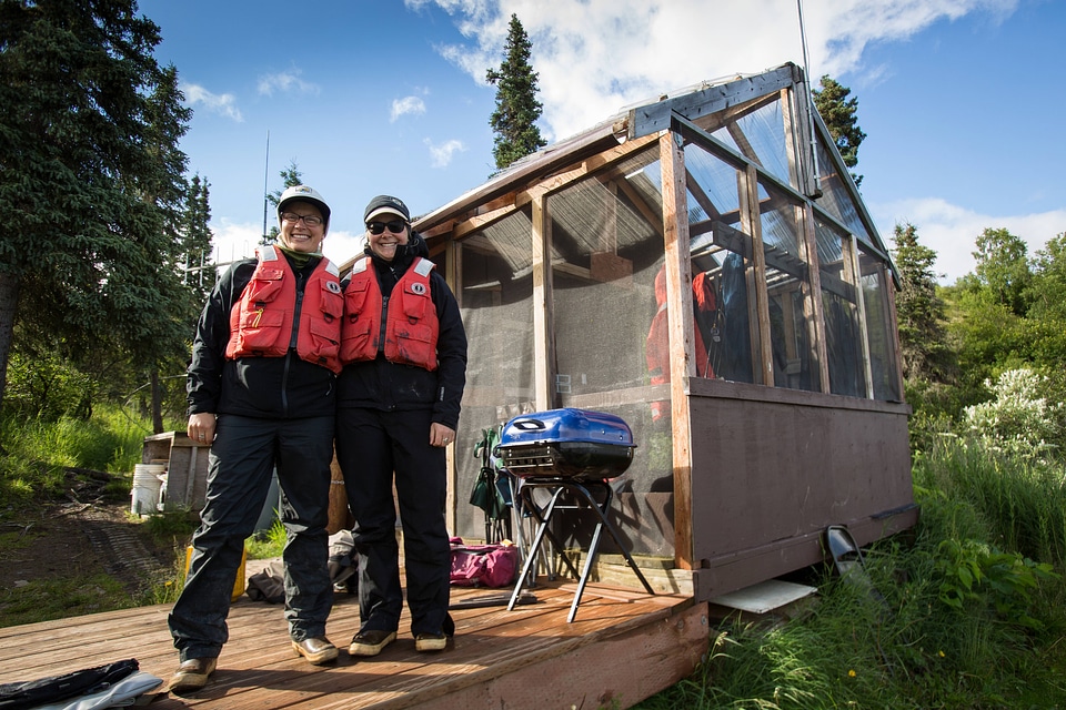 Biologists pose in front of wilderness camp