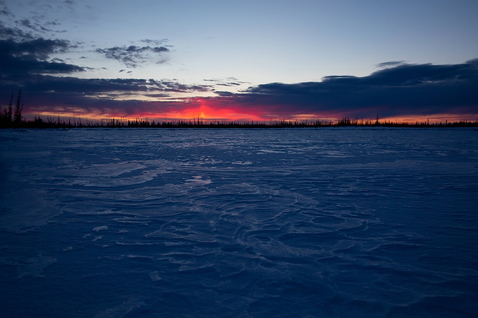 Sunset over the frozen lake