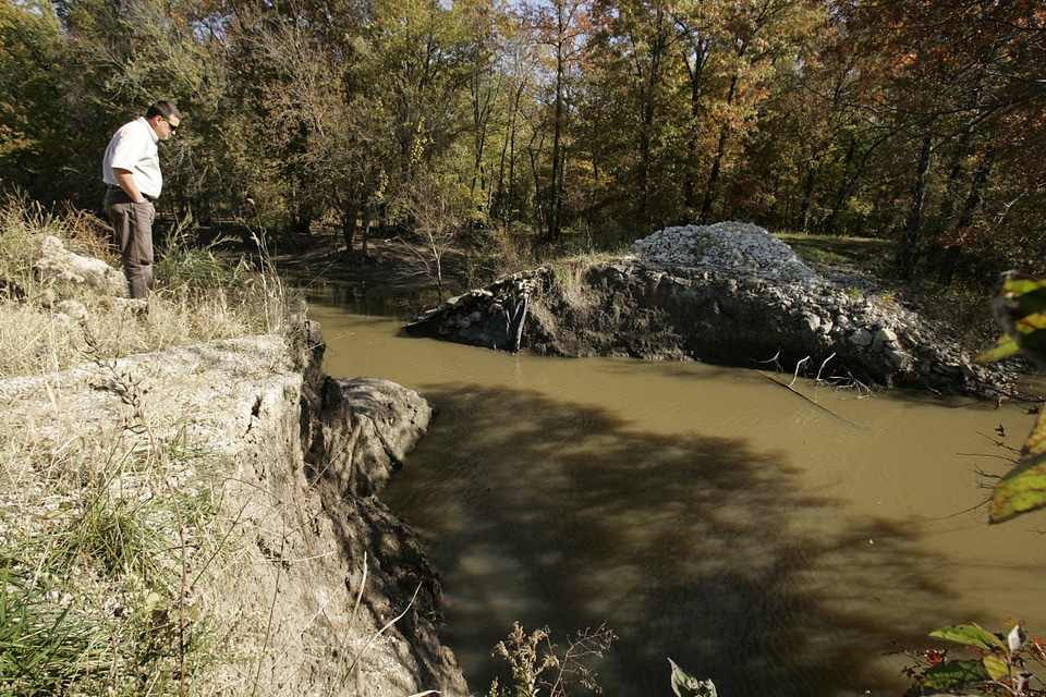 Employee looking at flooded area of the refuge