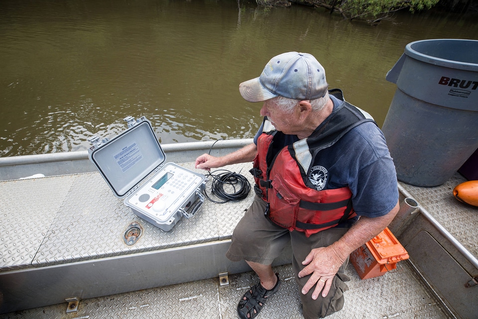 Biologist in boat study Gulf sturgeon in river-1