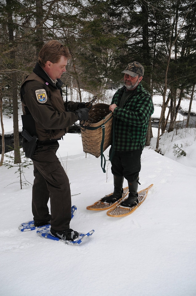 Service Law Enforcement Officer speaks to a trapper