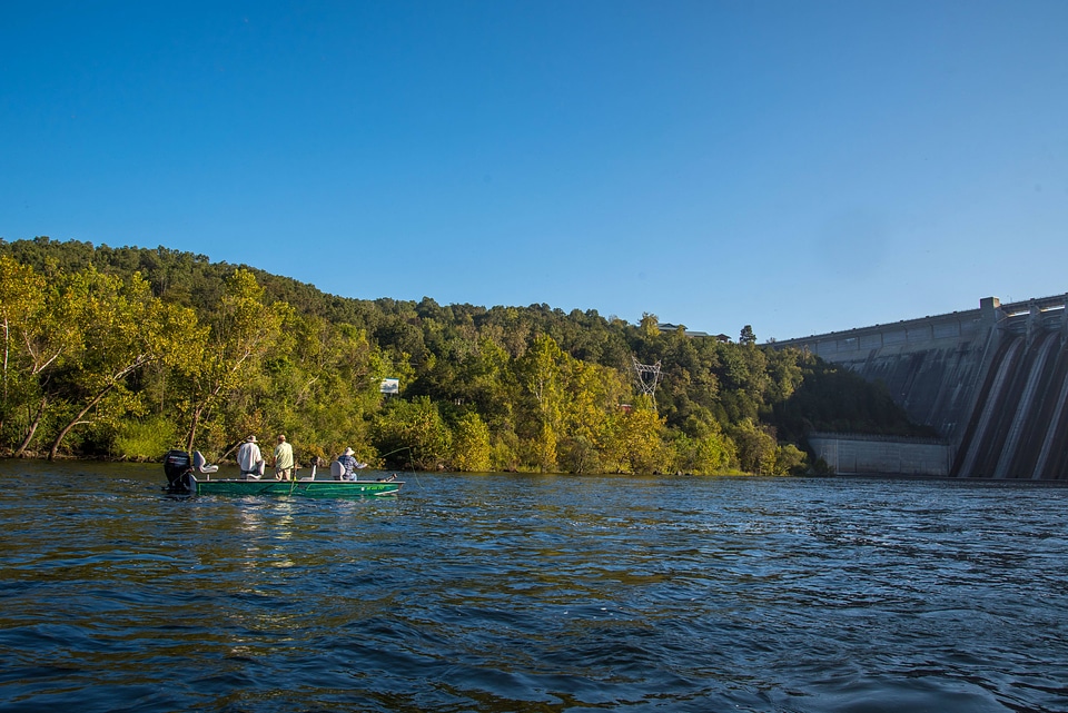 Group fishing in boat near Bull Shoals Dam on White River