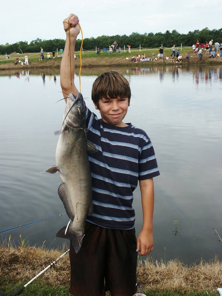 Boy catches huge catfish photo
